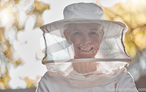 Image of Beekeeper, woman and protective suit in portrait, happy and outddor with ppe, safety and agriculture. Senior bee farmer, happy and beekeeping at farm, backyard or nature to work in honey production