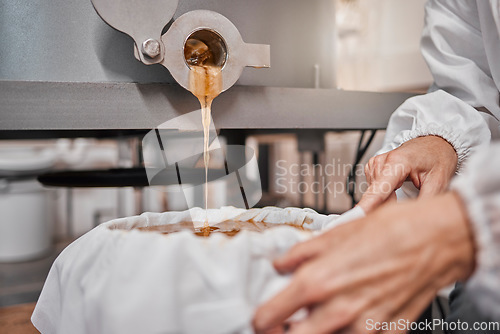 Image of Honey, hands and storage machine, product and manufacturing in warehouse, beekeeper workshop or factory. Person pouring, industry and production in agriculture farming, gold liquid and sustainability