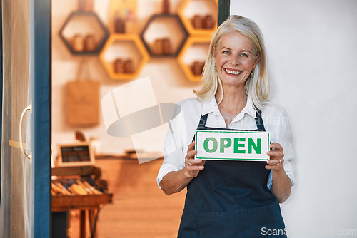 Image of Open sign, woman and small business for honey, retail and shop with smile in portrait and happy with natural product startup business. Elderly business owner, organic and raw, store with shopkeeper.