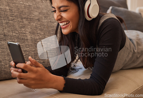 Image of Smartphone, headphones and woman on sofa listening to music, watch online video chat or mobile app zoom call. Excited, relax and music of a youth girl audio, podcast or online subscription streaming