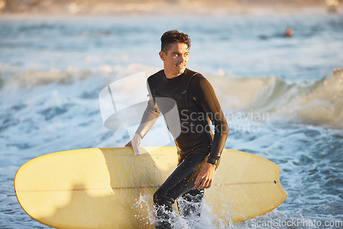 Image of Surfing, water sports and surfer man at beach for fitness, wave and adventure during summer travel in Australia. Happy man in sea with surfboard for freedom, training and professional sport