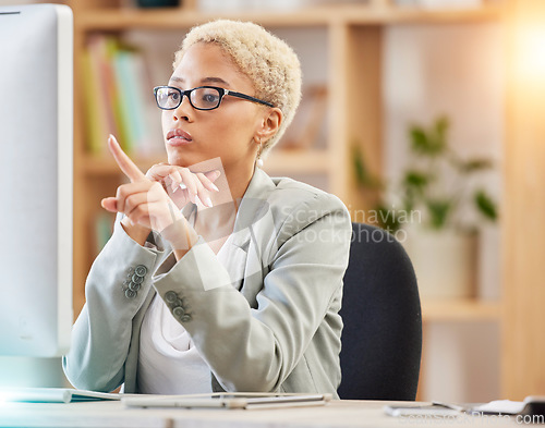 Image of Black woman, computer and office desk while pointing at screen for accounting, finance and analysis on web. Woman, pc and focus research, technology and reading documents, report or analytics at job