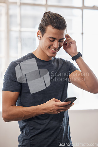 Image of Gym, man and smartphone, music and social media connection, fitness playlist and motivation, wellness or workout. Happy athlete, mobile app and audio radio listening, technology and training exercise