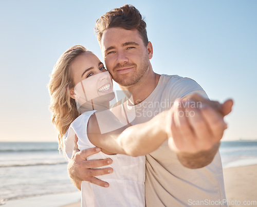 Image of Couple, portrait smile and hug for love, care or support in summer vacation bonding together at the beach. Happy man and woman holding hands smiling for relationship holiday break by the ocean coast