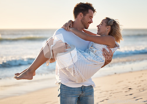 Image of Couple, beach and man carrying woman for love, relax and marriage support together on travel adventure or vacation. Freedom, trust and happy man at Hawaii ocean outdoor for quality time in sunshine