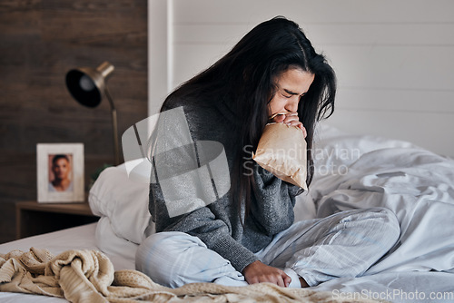 Image of Woman, anxiety and paper bag stress breathing on bed in house or home bedroom in divorce crisis, marriage fail or widow grief. Mental health, panic attack and depression loss person in control breath