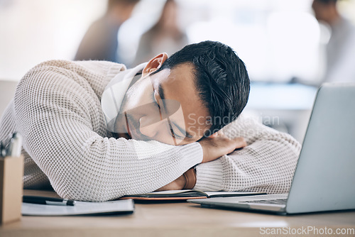 Image of Tired, burnout and businessman sleeping on desk in corporate office after working on laptop. Stress, headache and male worker asleep with head on table with notebook and computer, exhausted from job