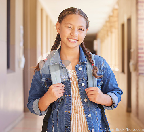 Image of School, Backpack and portrait of girl student with education to learn, study and have knowledge. Happy, smile and child standing in the hallway or aisle with her bag for class in a high school campus
