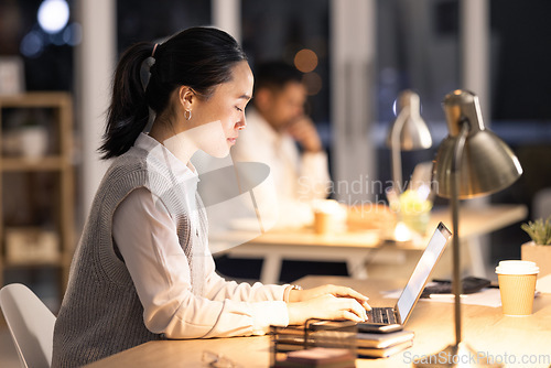 Image of Night, laptop and woman with digital marketing research for creative social media posts, content and ideas. Focus, startup and Japanese worker typing or working on an advertising strategy in a office