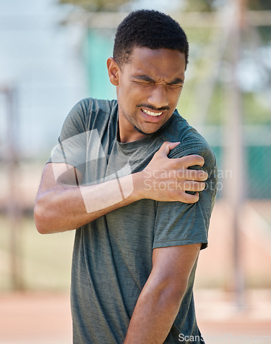 Image of Fitness, man and shoulder pain by runner after exercise, training and morning run in city on blurred background. Arm injury, sport and athletic guy suffering from muscle, arthritis or cardio distress