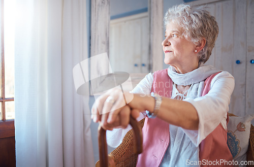 Image of Senior woman, cane and thinking in home, nostalgic or contemplating old memory. Disability, support and retired female with walking stick relaxing, focus or lost in thoughts alone in lonely house.