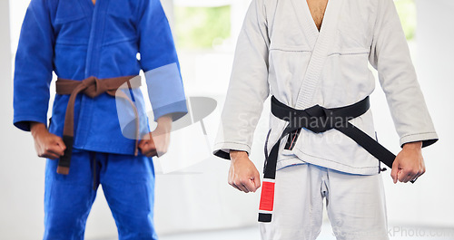 Image of Karate, dojo and men in uniform for training, exercise or a fight competition, tournament or championship. MMA, martial arts and fighter athletes in a gi suit for a workout or practice in a gym.