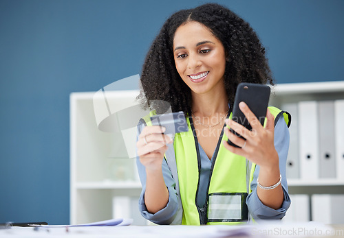 Image of Woman, ecommerce and credit card with phone for shopping, payment and bank technology in office. Happy black woman, online shopping and fintech at architecture, construction or contractor workplace