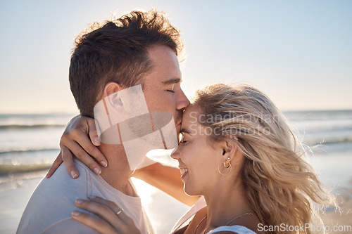 Image of Love, dating and couple kiss at beach enjoying romantic holiday, vacation and honeymoon by ocean. Happiness, summer and young man and woman embrace, show affection and bonding together in nature