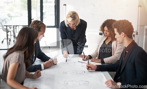 Image of Business people, architect and blueprint in meeting, planning or team brainstorming on table at office. Group of contract engineers in teamwork, floor plan or documents for industrial architecture