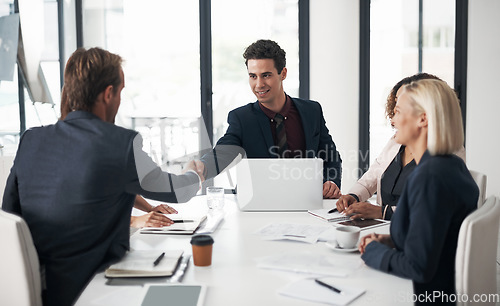 Image of Businessman, handshake and meeting for deal, partnership or b2b in teamwork at office conference. Business people shaking hands in recruiting, hiring or deal agreement for team growth at workplace