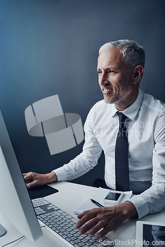 Image of Typing accountant, computer and mature man in studio, working and isolated on a dark background mockup. Focus, writing and happy manager at desktop for reading email, research or business auditor.