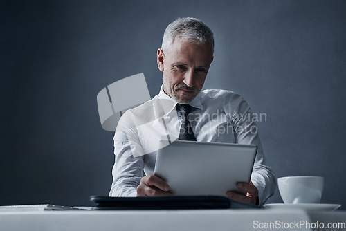 Image of Tablet, accountant and mature business man in studio isolated on a dark background mockup space. Technology, reading and senior manager at desk for working on project, audit email or research app.