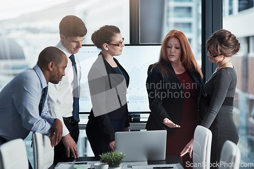 Image of Collaboration, business meeting and team working on a project in the office conference room. Teamwork, diversity and professional employees planning research on a laptop in the workplace boardroom.