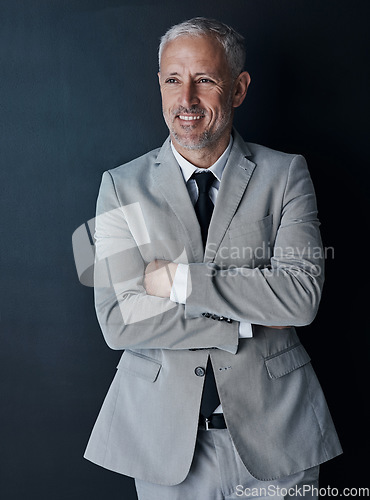 Image of Senior businessman in suit, arms crossed and smile on dark background, happy lawyer in studio. Confidence, pride and professional career for executive ceo attorney, business owner and law firm boss.