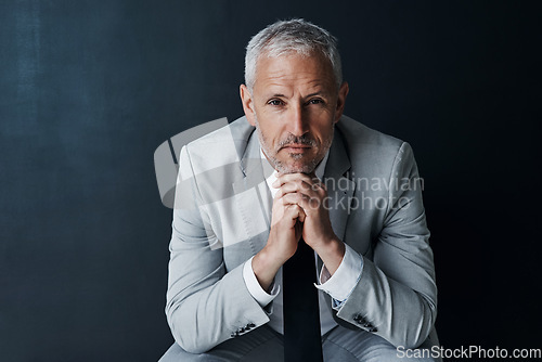 Image of Serious portrait of senior attorney sitting with confidence, mockup space and dark background in studio. Pride, professional career ceo and executive lawyer man, mature businessman or law firm boss.