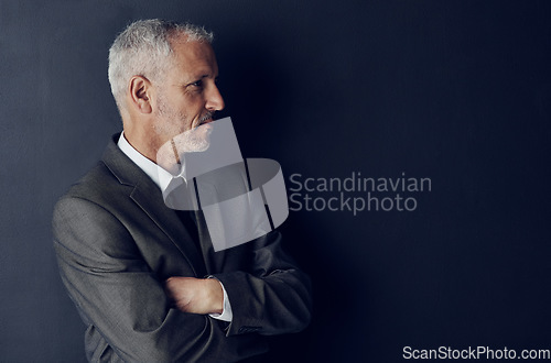 Image of Senior executive, business man and arms crossed, confidence and management on dark background. Male CEO, corporate director in suit and ambition, mockup space with empowerment and career in studio