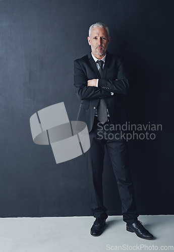 Image of Portrait, serious and confident businessman with arms crossed in pride, lawyer or attorney on dark background. Boss, ceo and professional business owner, proud senior executive director at law firm.