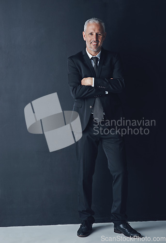 Image of Senior executive, business man and arms crossed with full body portrait, confidence and management on dark background. Male CEO, corporate director in suit and ambition, empowerment and career