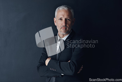Image of Senior executive, business man and arms crossed with confidence in portrait and management on dark background. Male CEO, corporate director and suit with ambition, empowerment and career in studio