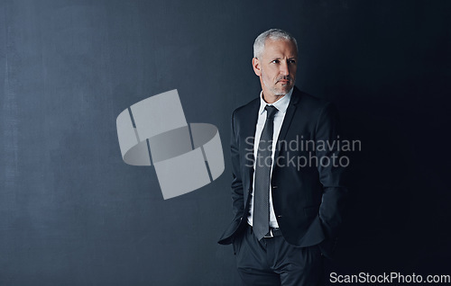 Image of Senior executive, business man and confidence in studio, management and professional mindset on dark background. Male CEO, corporate director and suit with ambition, empowerment and mockup space
