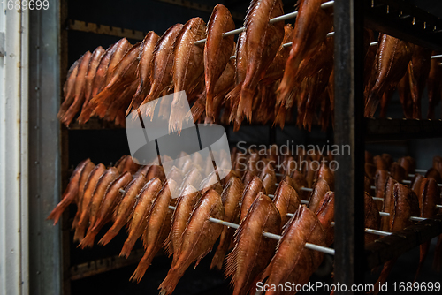 Image of Smoking sea bass fish in smokehouse box