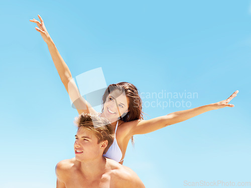 Image of Piggyback, freedom and a couple at the beach in summer for bonding, holiday or an ocean date. Smile, love and a man and woman being playful at the sea for a vacation, happiness or travel in Bali