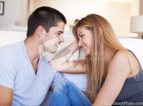 Image of Talk, relax and couple bond on a sofa with conversation, gossip and hangout in their home together. Love, smile and happy woman with man in a living room with care, happy and soulmate connection