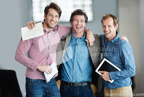 Image of Team, portrait or business developers hug after meeting for support in office together with smile or unity. Confident men, people or happy programmers with technology, notes or notebook in workplace