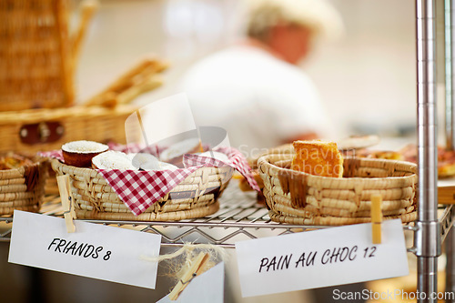 Image of Bakery, window and shop with pricing of dessert, cake or food in cafe with advertising, product and store presentation. Sugar, goods and baked pastry, treats or muffin in a basket or small business