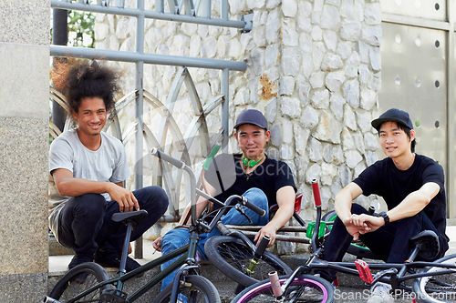 Image of Portrait, bmx group and bicycle in city, outdoor and relax together in street. Cycling, people smile and happy friends with urban bike for sports, exercise or workout for fitness, health or wellness.