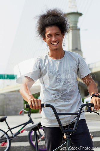 Image of Portrait, bmx and man with bicycle in city, outdoor and training in street. Cycling, funny or person laugh with bike to travel in Brazil for sport, exercise or workout for fitness, health or wellness