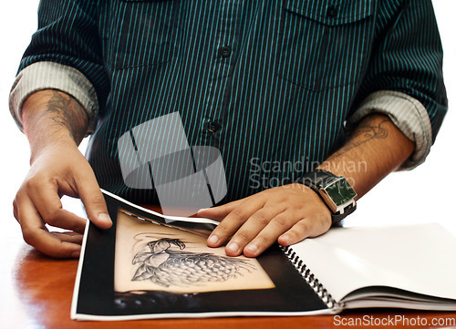 Image of Hands, search and book for a tattoo design, picture choice or inspiration for body art at a studio. Closeup, paper and a man with a check on photos for ink, creativity and decision for tattoos