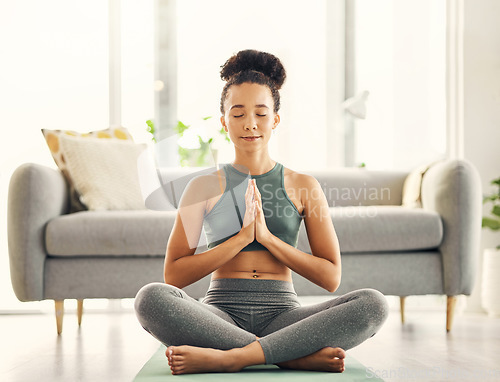 Image of Meditation, praying hands and woman relax on living room floor for peace, wellness or mental health at home. Prayer pose, yoga and lady meditate in lounge for zen, peace or holistic breathe exercise