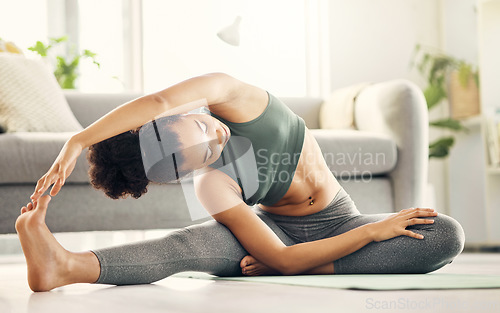 Image of Stretching, yoga and woman on a living room floor for training, exercise or mental health at home. Legs, stretch and lady with flexible fitness or pilates workout for balance, meditation or wellness