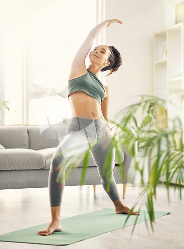 Image of Yoga, wellness and woman in home with zen, relax and spiritual practice in a living room. Young female person, apartment and lounge with pilates and flexibility exercise in house feeling calm