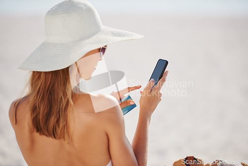 Image of Credit card, phone and travel with woman on beach for online shopping, payment and fintech. Relax, summer and tropical vacation with back of female customer for ecommerce, trip deal and finance