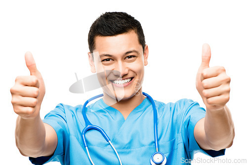 Image of Thumbs up, pride and portrait of a male doctor in a studio for a medical consultation with confidence. Happy, smile and professional young man nurse with an approval hand gesture by white background.