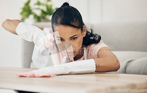 Image of Woman, chemical spray and cleaning wooden table, hygiene with household maintenance and detergent. Female cleaner, disinfectant and wipe or clean dirt with cloth from surface and janitor service