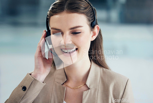 Image of Call center, listening or happy woman in telecom, CRM or telemarketing office for customer services. Microphone headset, smile or friendly female sales agent in tech support help desk for consulting