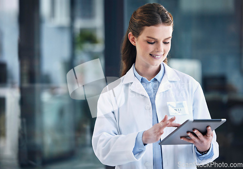 Image of News, tablet or happy doctor in hospital with research on online media to search for medicine info. Woman, smile or medical healthcare professional browsing on technology for telehealth in clinic