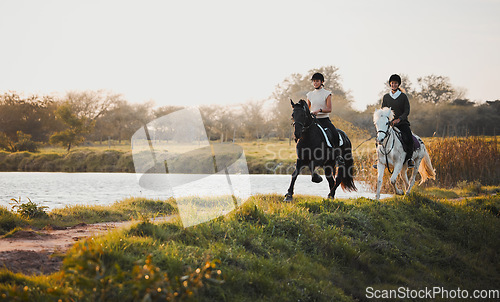 Image of Horse riding, freedom and equestrian with friends in nature on horseback by the lake during a summer morning. Countryside, hobby and female riders outdoor together for travel, fun or adventure