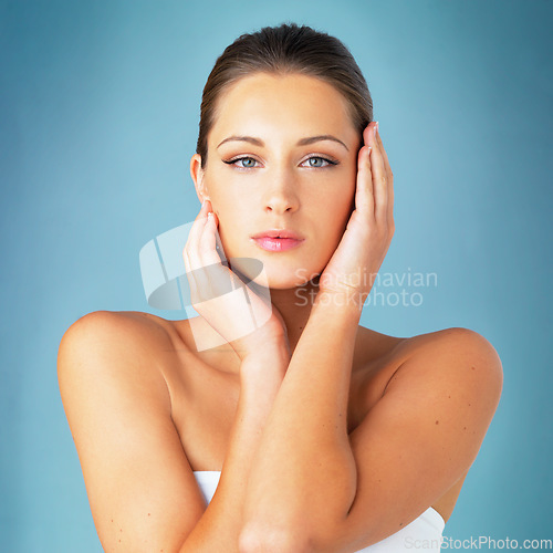 Image of Skincare, cosmetics and beauty, portrait of woman with dermatology and makeup on blue background. Shine, skin care and wellness, fresh face of model with beauty and facial glow on studio backdrop.