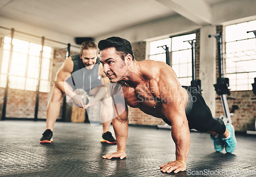 Image of Push up, fitness and man or personal trainer in gym support, motivation and helping body builder in training. Muscle, strong and focus of people exercise or workout on floor, advice or accountability
