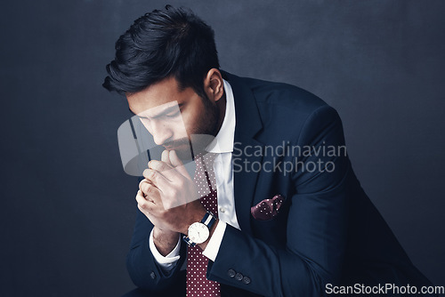 Image of Business, thinking or Indian man with anxiety, fail or consultant against a dark studio background. Male person, employee or agent with stress, mistake or financial report with depression or confused